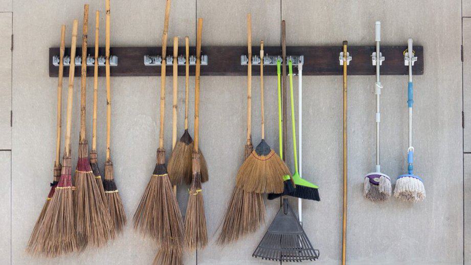 broom and mop holder on a wall