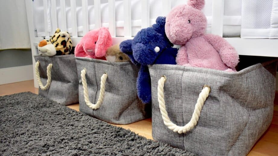 stuffed animals in storage bins under bed