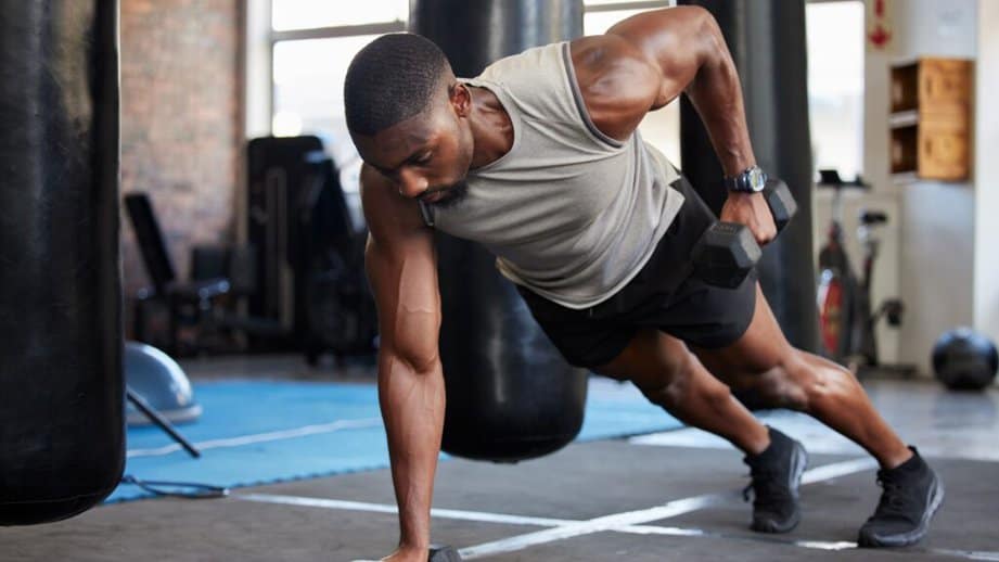 man working out at a gym with weights