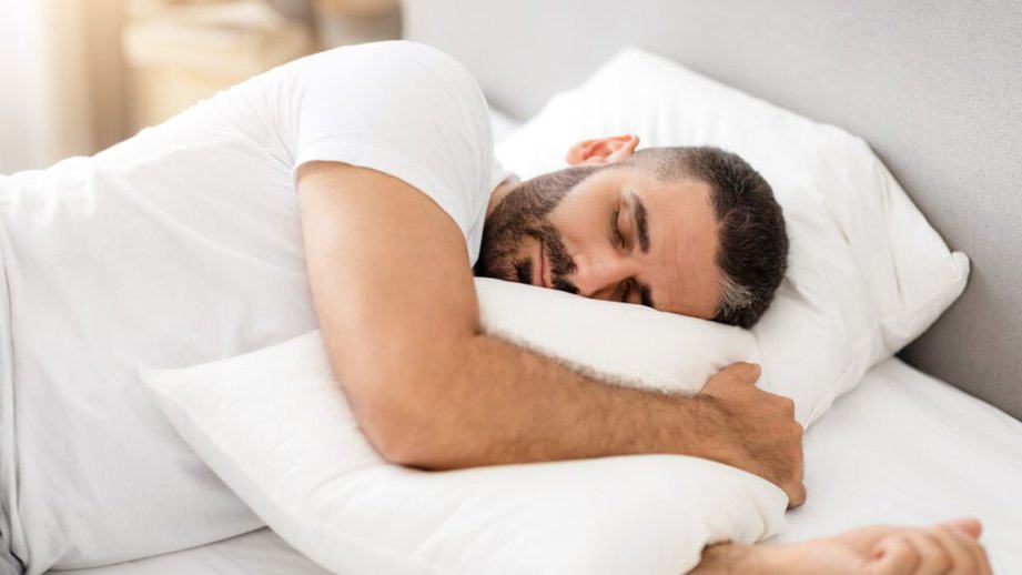 man asleep in bed