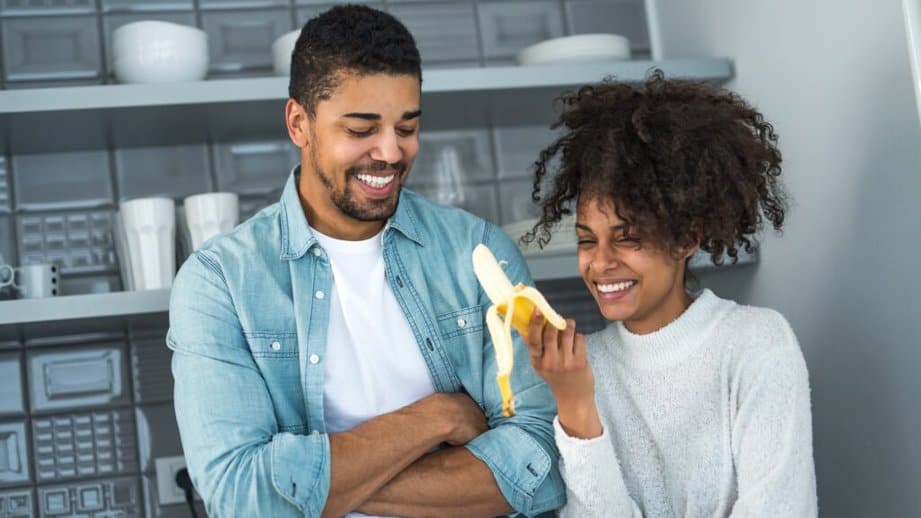 happy couple holding a banana