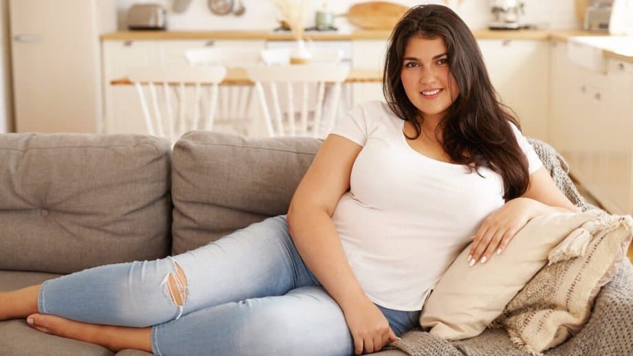 plus sized woman sitting on couch