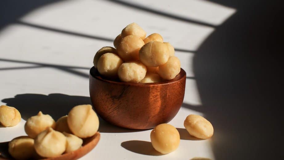 small wooden bowl of macadamia nuts