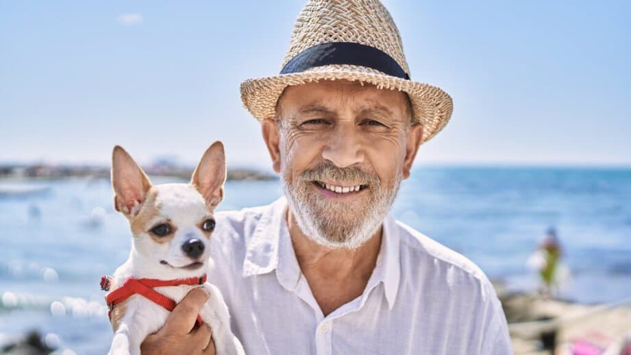 Older man in a hat with a dog