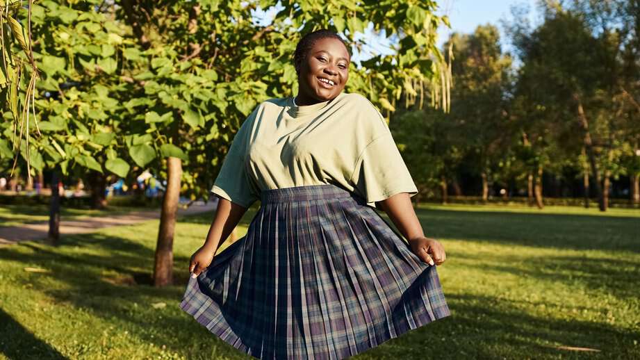 curvy woman in a skirt outside