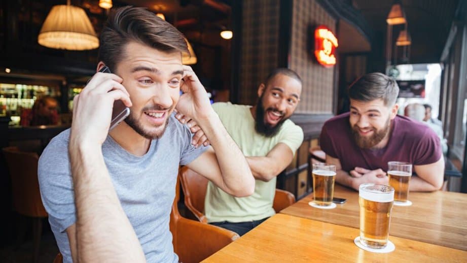 Man talking at phone while at a bar