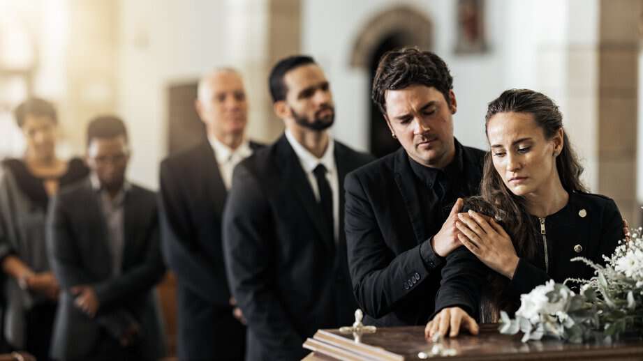line of people at a funeral