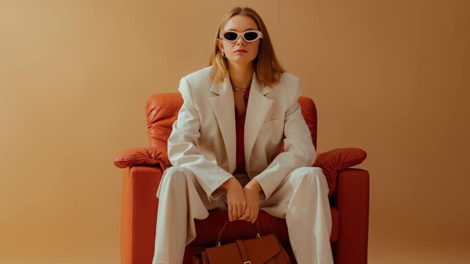 woman sitting in chair with shoulder pads