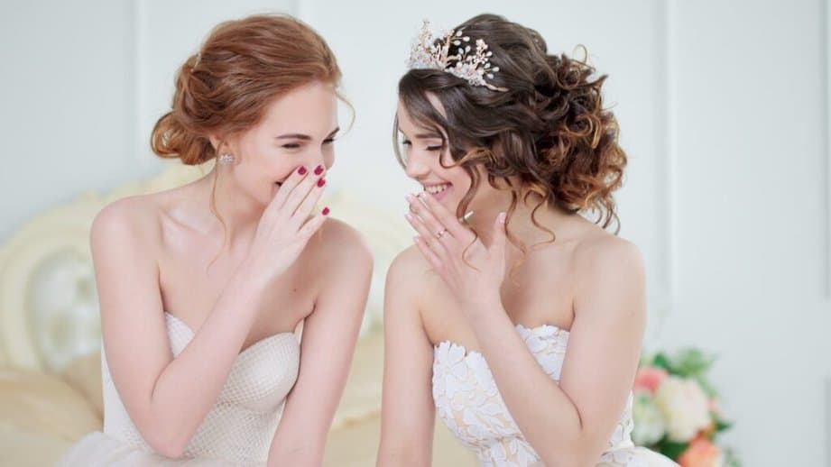 bride whispering to a friend 