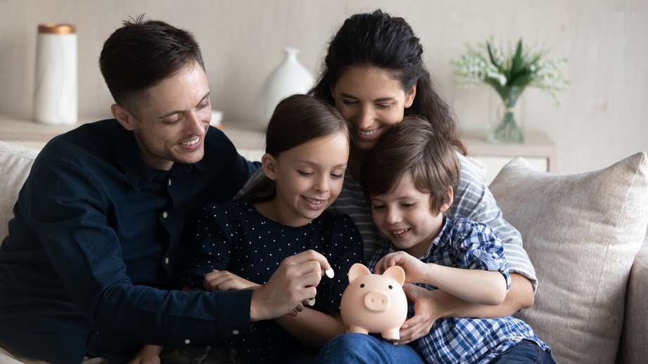 family saving money in a piggy bank
