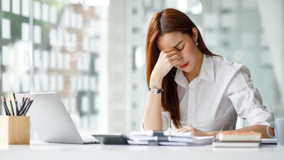 woman looking stressed while at work