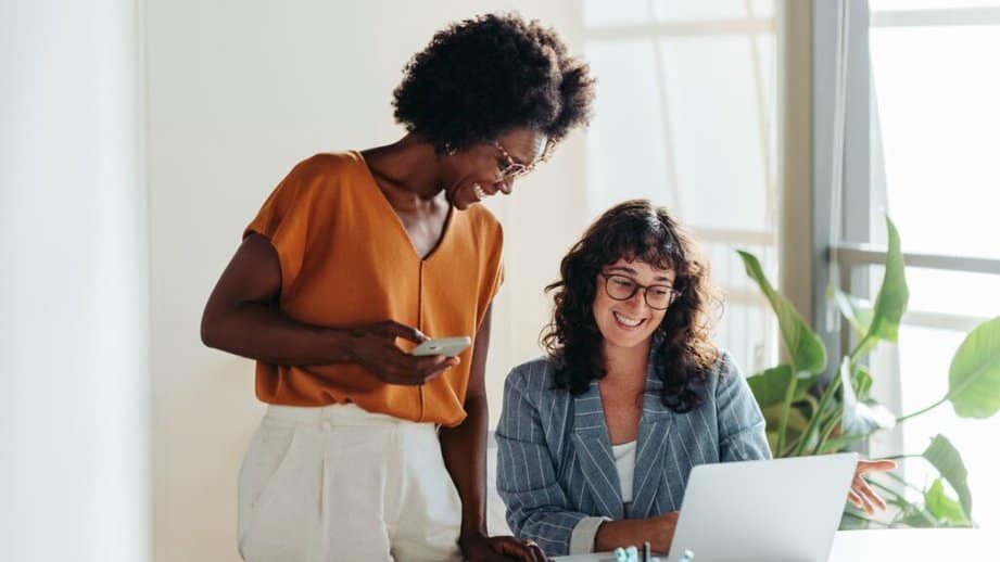 two women working together on a computer