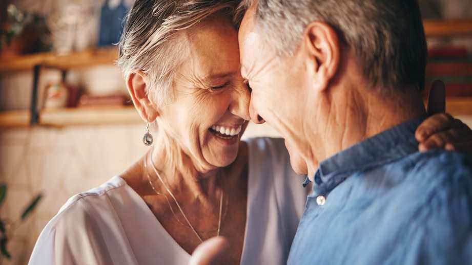 happy mature couple dancing at-home date night