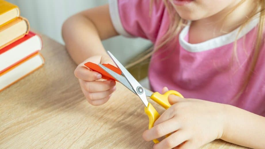 kid using scissors
