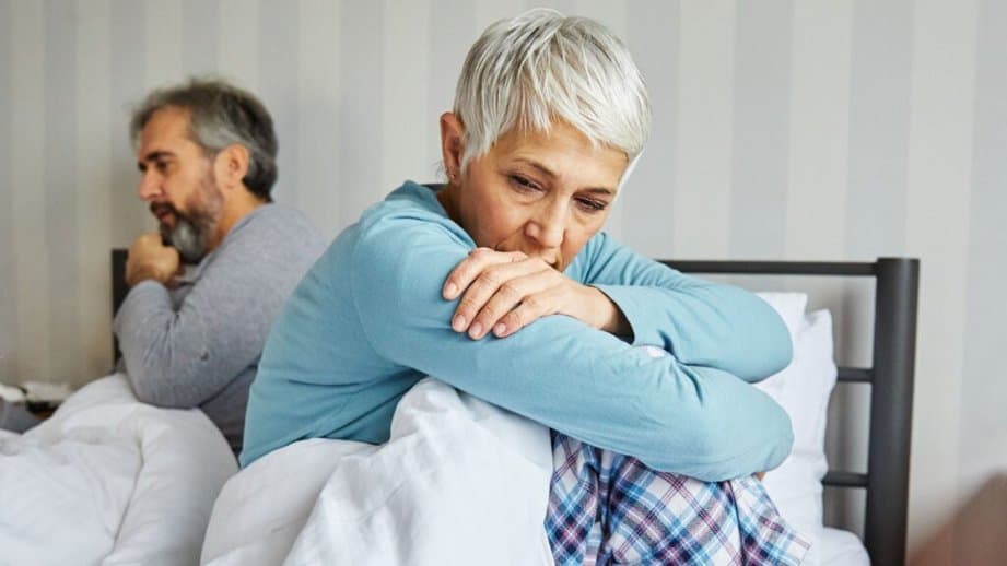 middle aged mature woman fighting with husband in bed