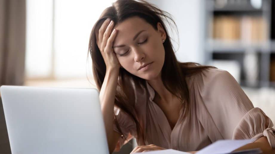 woman burned out at work at her desk