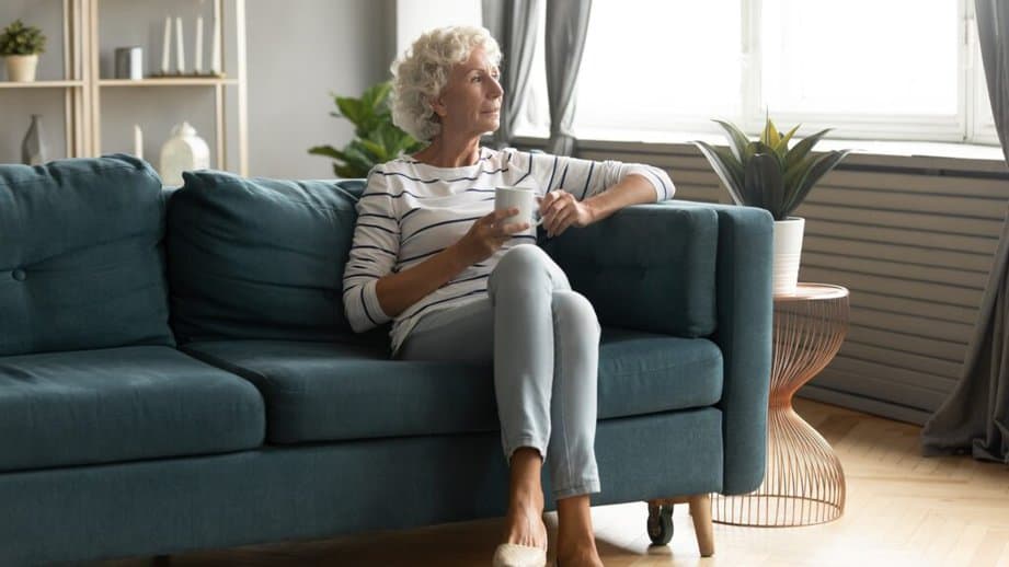 older woman sitting alone on a couch
