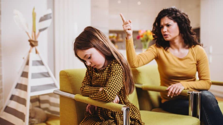 mother yelling at daughter on couch
