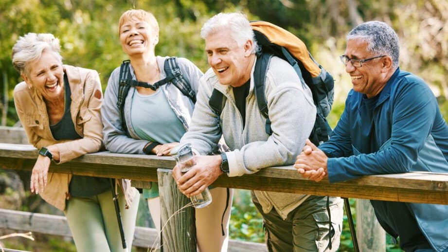 older group of friends outside on a hike