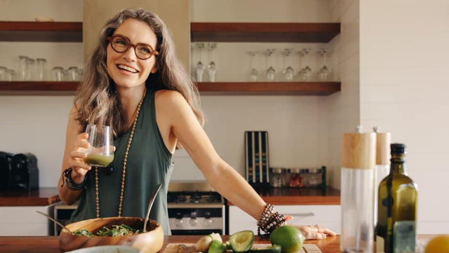 older woman smiling and drinking juice