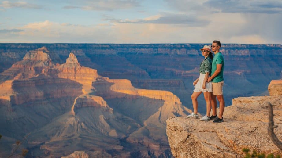 couple standing on top of a canyon