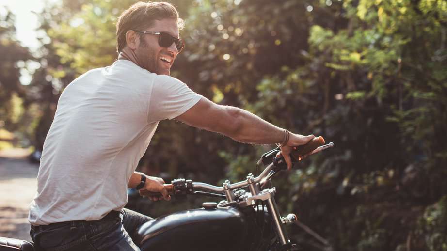 man on a motorcycle in a white tshirt