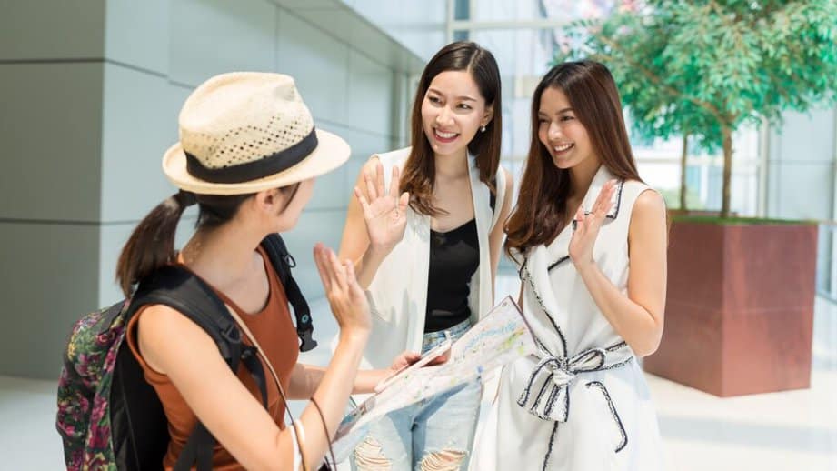 woman traveler saying goodbye to friends