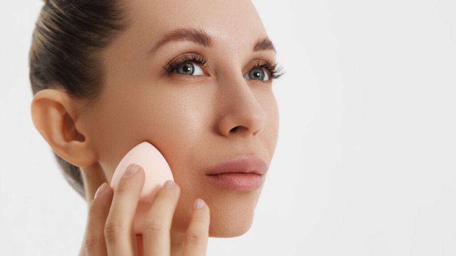 woman using dry makeup sponge