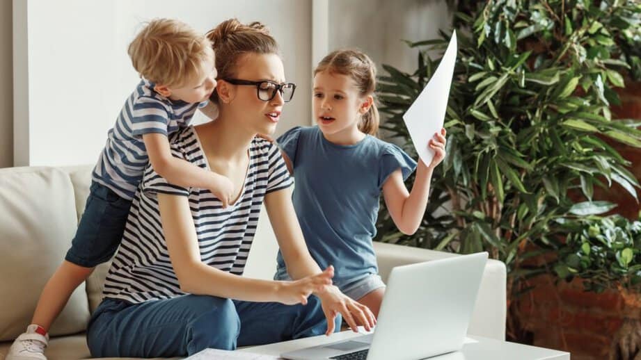 stressed woman working from home with kids