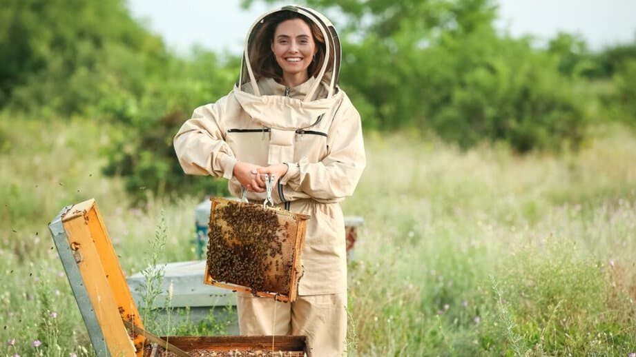 woman bee keeper holding a tray
