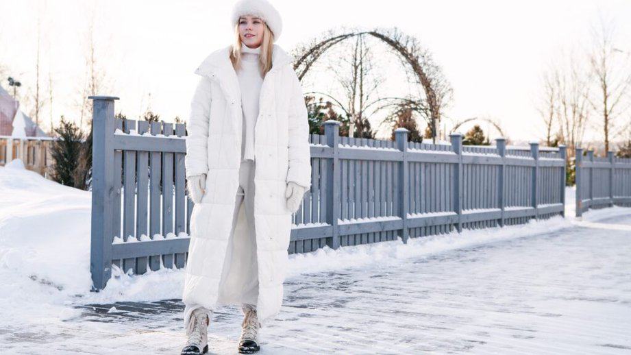 woman wearing a long white winter coat