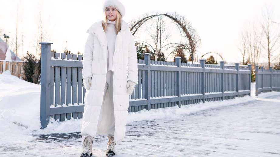woman wearing a long white winter coat