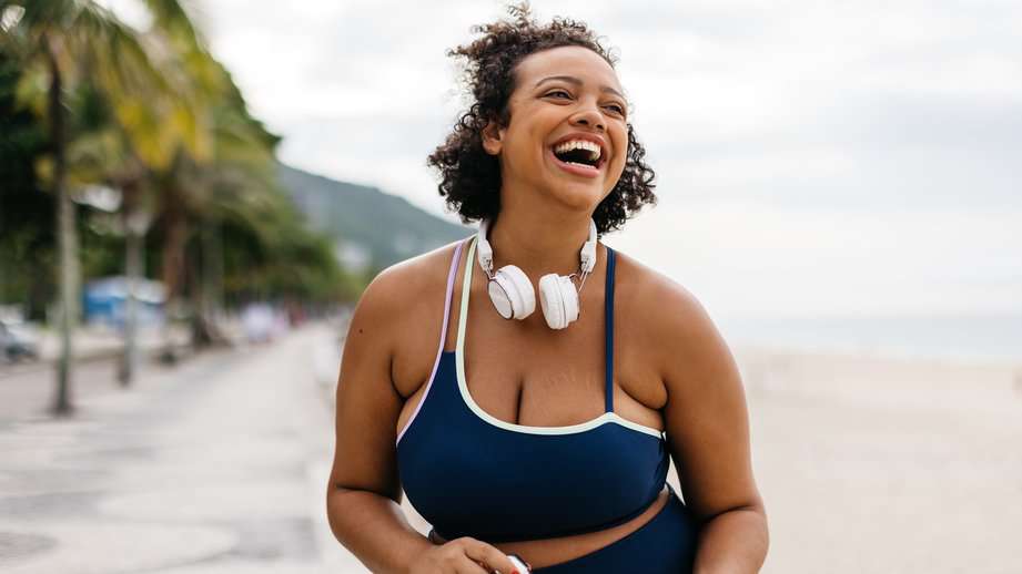 happy plus sized woman exercising outside