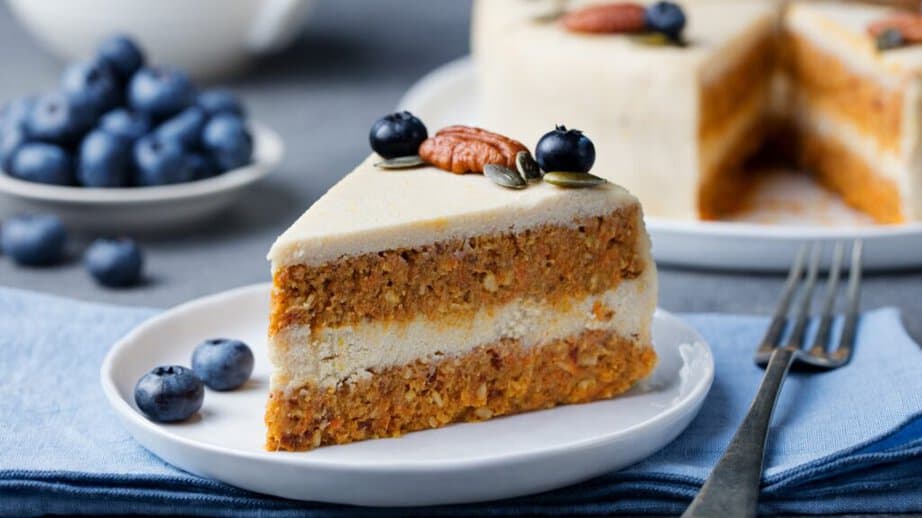 vegan slice of carrot cake with blueberries on top