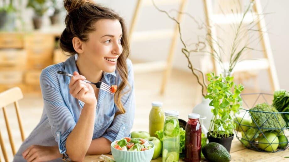 woman happily eating a salad