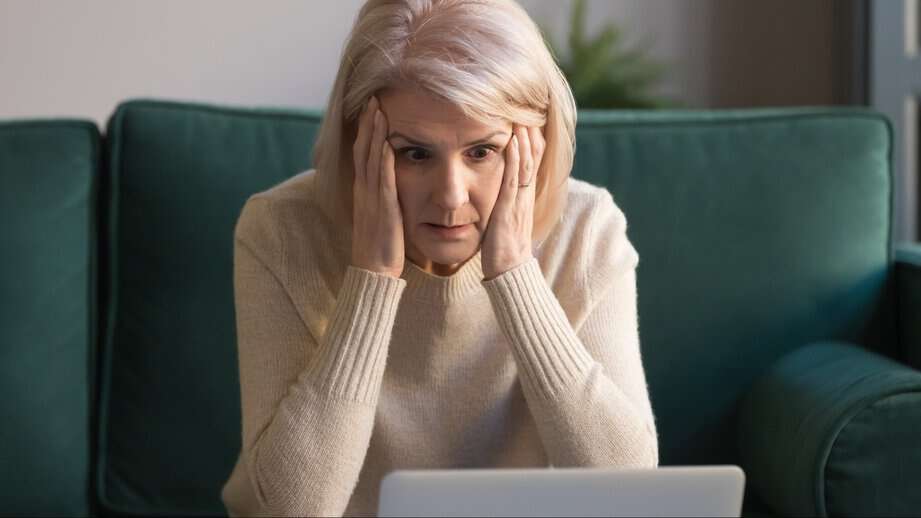woman looking at laptop in surprise