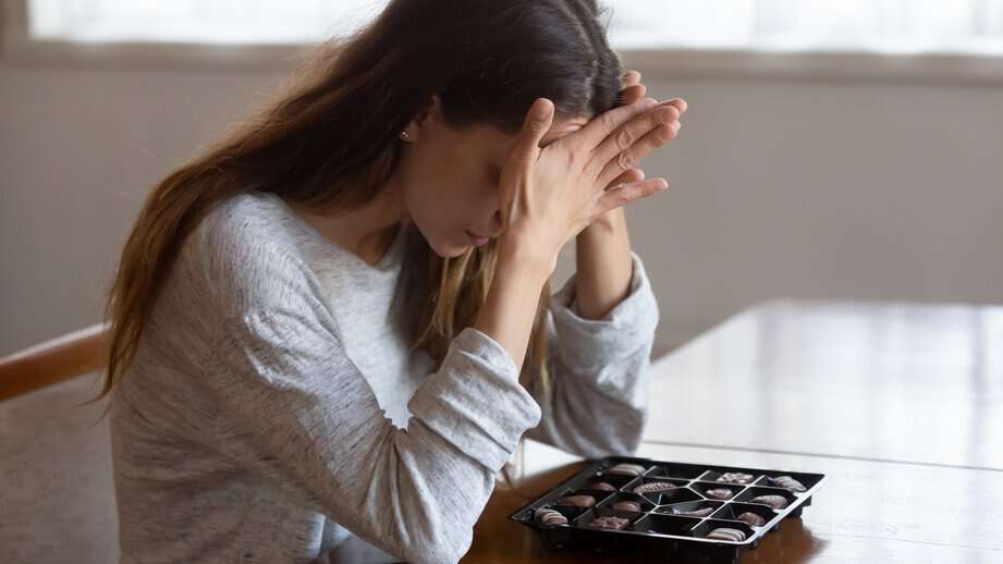 woman upset with a box of chocolates