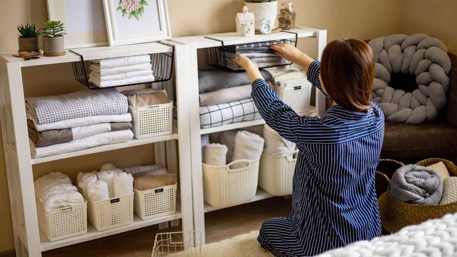 woman organizing home shelves