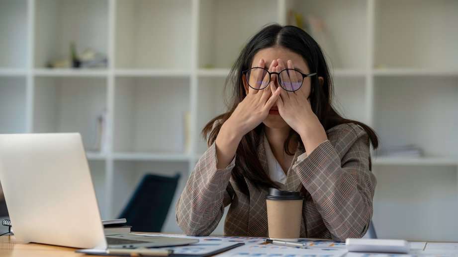 tired stressed woman at her desk