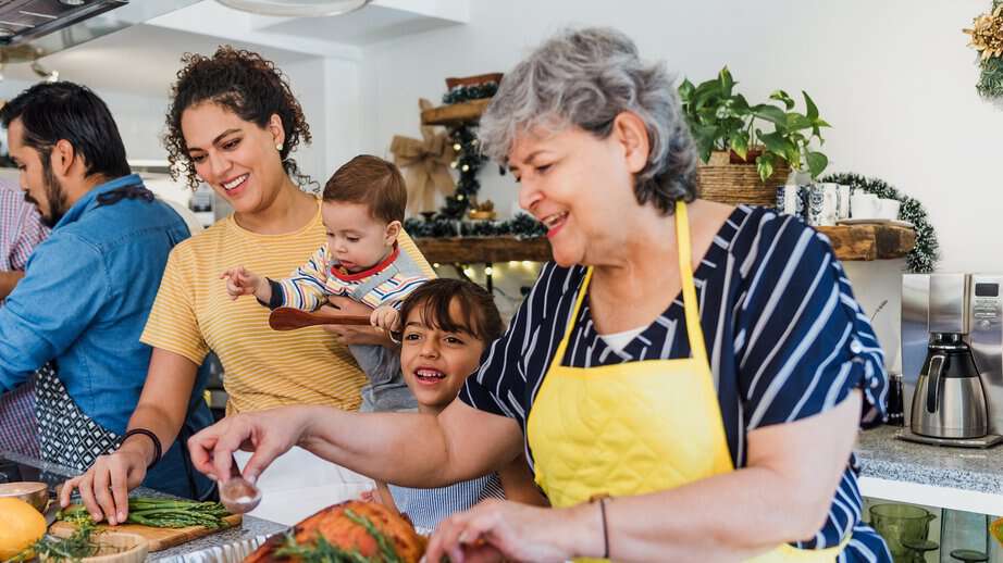 family cooking a big meal in the kitchen