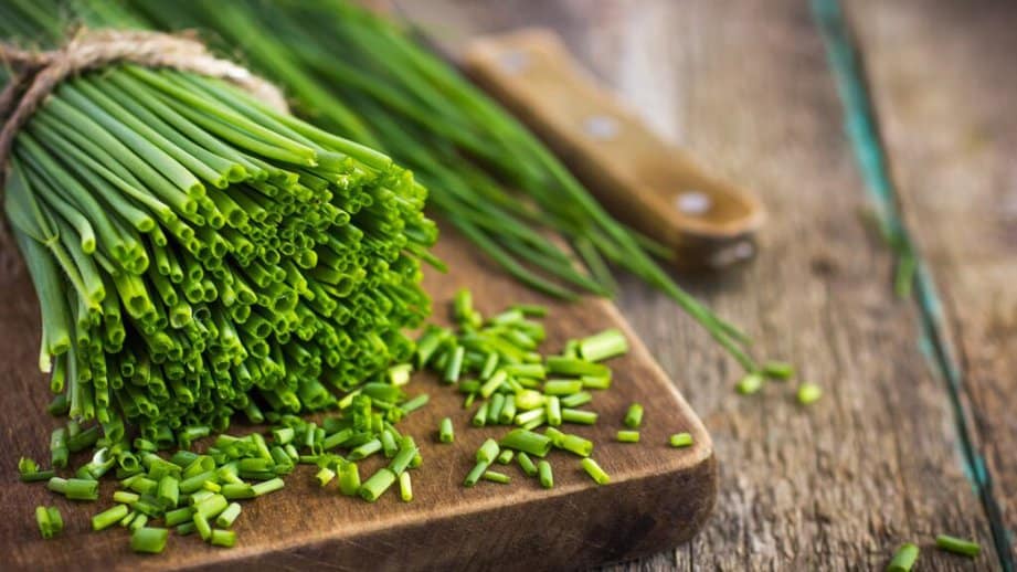 bunch of fresh chives on a cutting board
