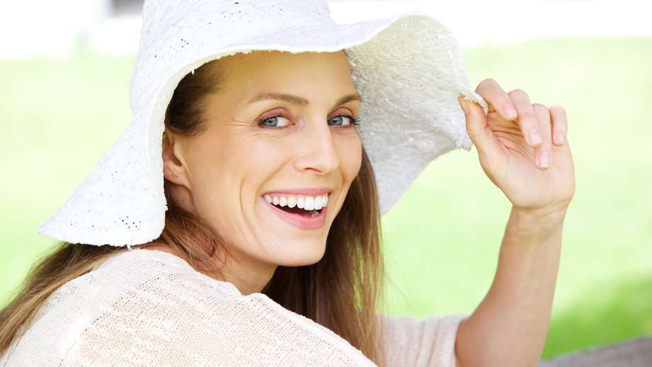 happy woman smiling in a hat